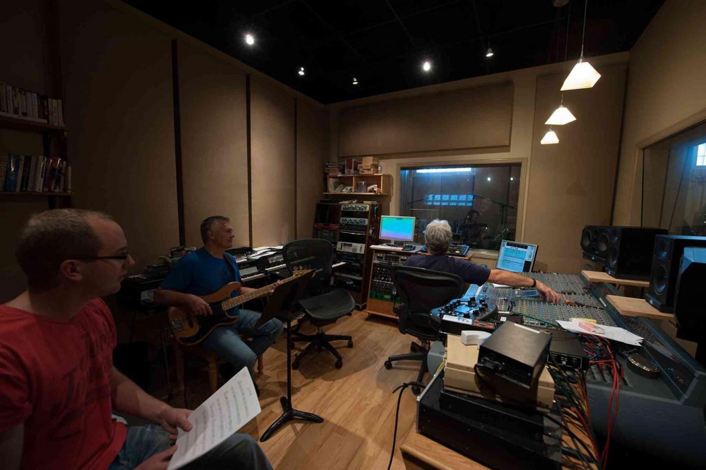 Allan and Roy discuss the bass part with the musician.